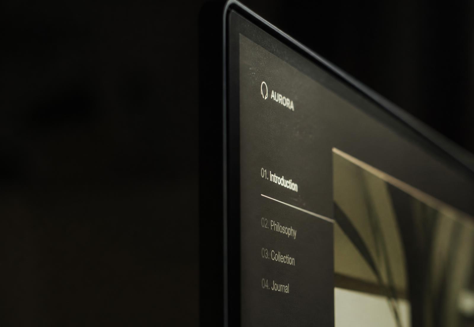 Macro of a monitor edge showing a minimal interface glowing in darkness
